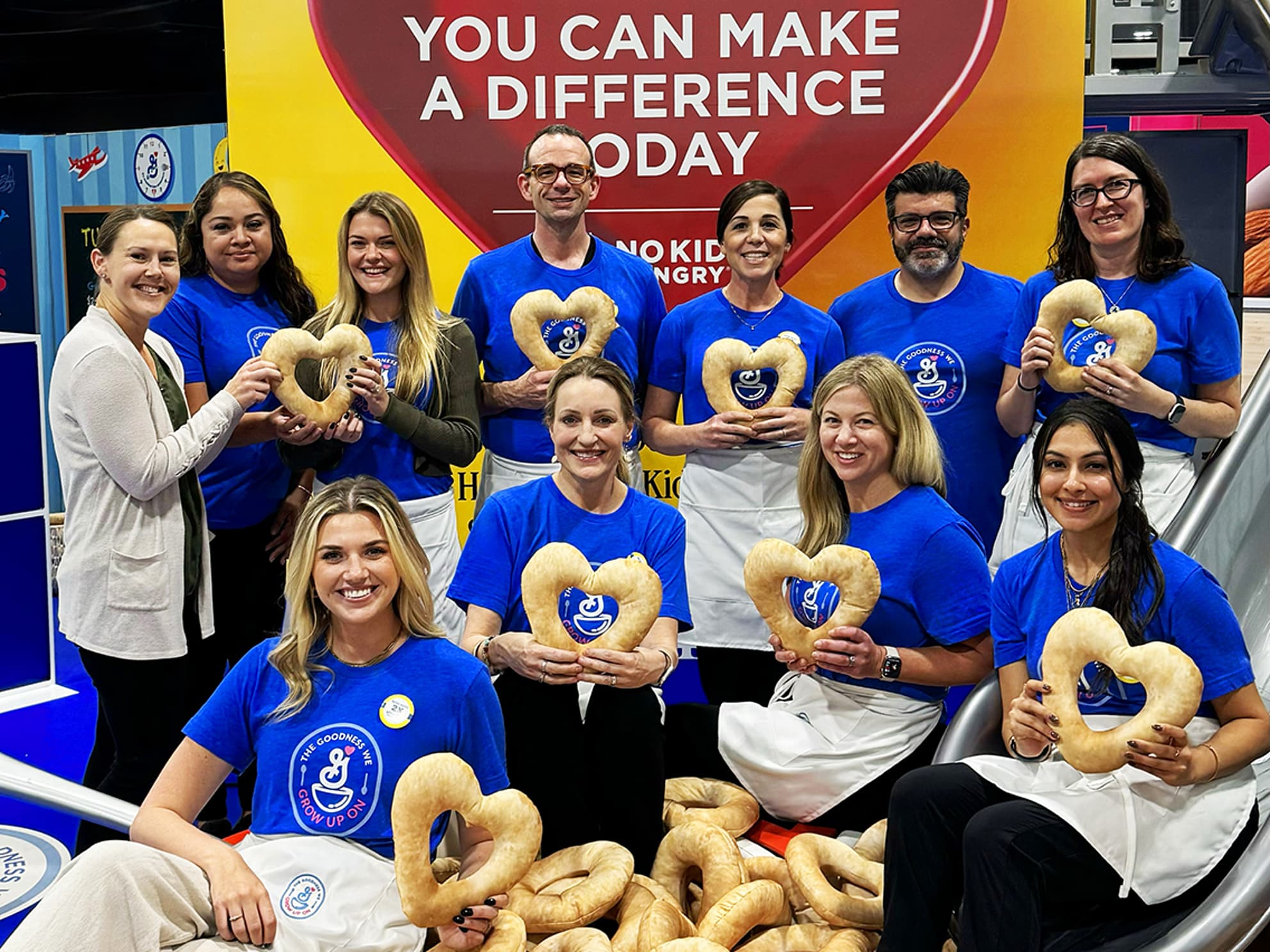 employees holding heart-shaped cheerios